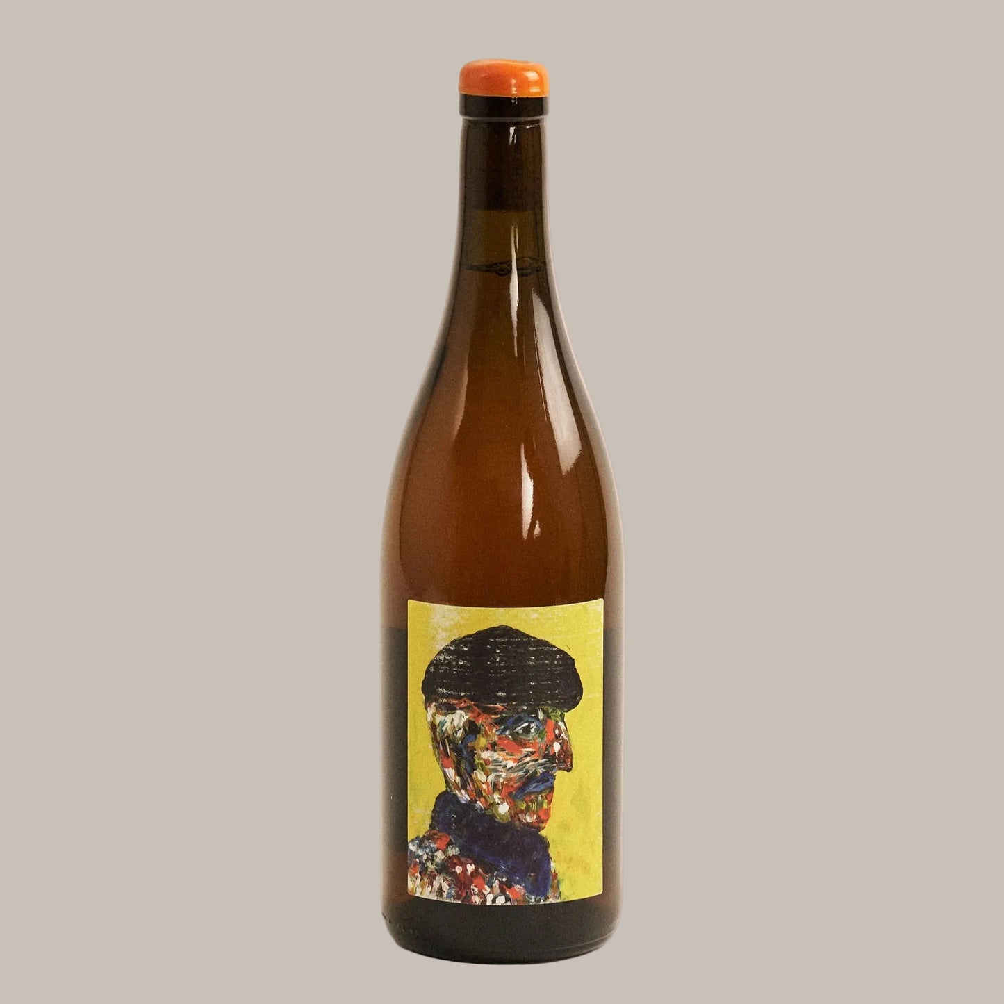 Brown bottle with a colorful label featuring a face on a beige background