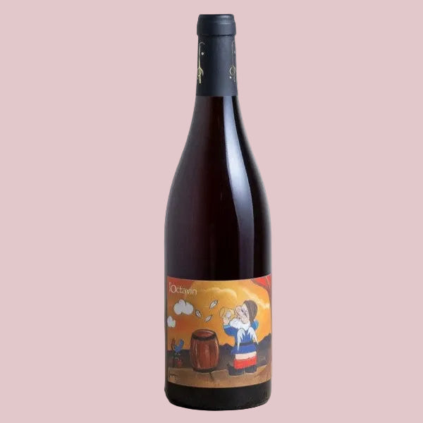Wine bottle with a colorful label on a beige background