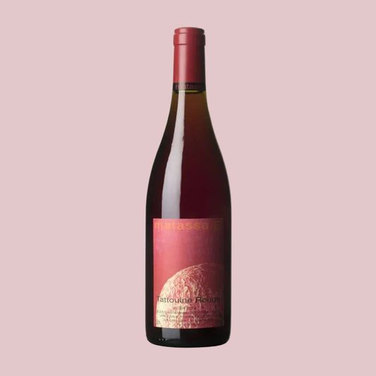 Wine bottle with a red label on a pink background