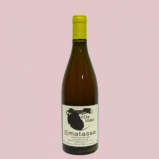 Wine bottle with yellow cap and white label on a light gray background